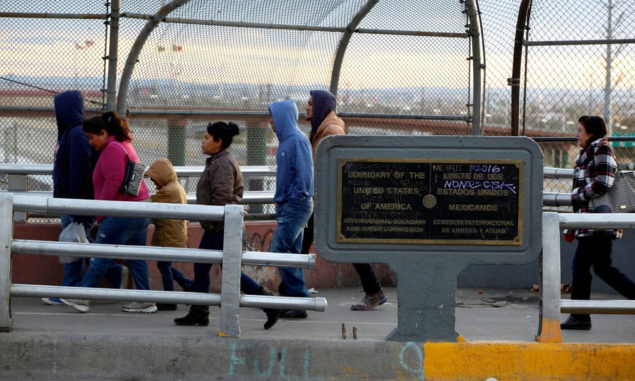 People walk on the international border bridge Paso del Norte to cross to El Paso from Juarez 