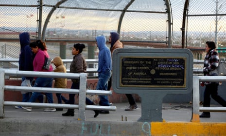 People walk on the international border bridge Paso del Norte to cross to El Paso from Juarez 