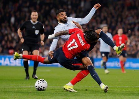 England’s Noni Madueke goes down in a tackle with Uruguay’s Rodrigo Aguirre