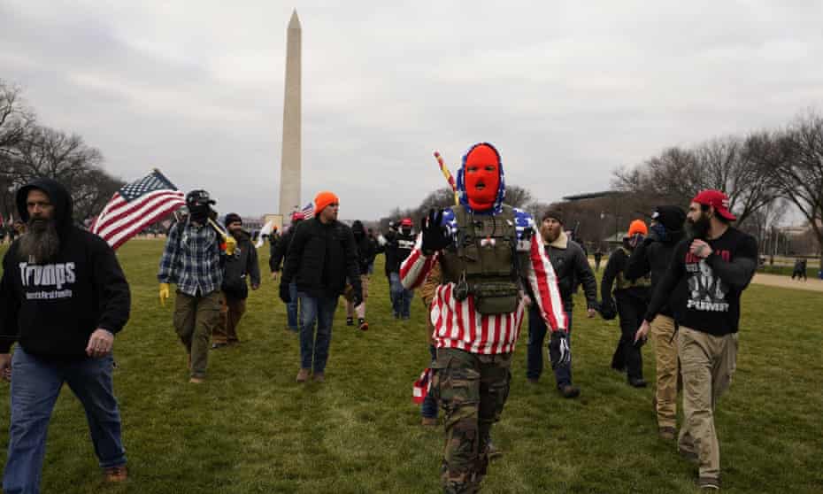 People who self-identify as members of the Proud Boys attend a rally in Washington DC in support of Donald Trump on 6 January 2021. 