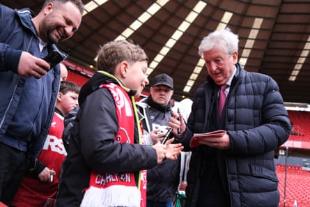 Roy Hodgson signs autographs before the match