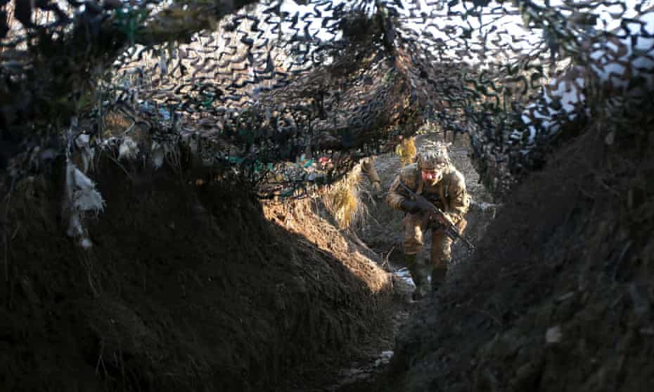 A member of the Ukrainian territorial defense forces, the country’s military reserve, walks in a trench on the frontline with Russia-backed separatists near to Avdiivka, Donetsk, south-eastern Ukraine, on Saturday.