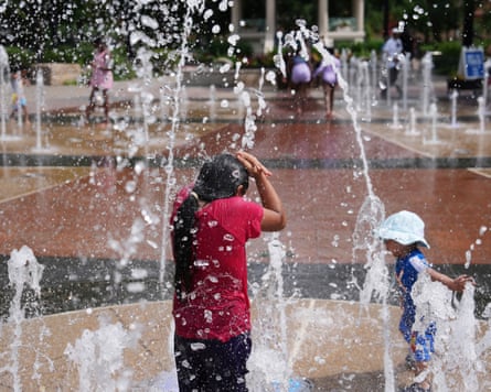 A child stands on a splash pad in Cincinnati, Ohio on 20 June 2025.