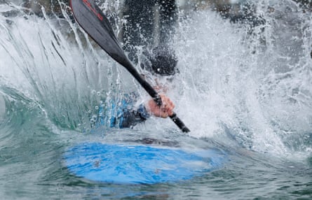 Joe Clarke is splashed with water in his canoe while training.
