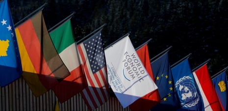 The national flags of several countries and a flag with the logo of the World Economic Forum (WEF)