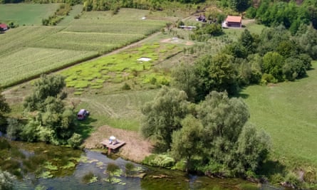 An aerial view of the cabin in the countryside, by the river.