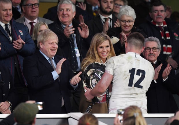 Boris Johnson and partner Carrie Symonds with the England captain Owen Farrell at Twickenham on 7 March.