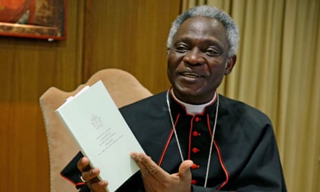 Cardinal Peter Turkson with a copy of Pope Francis’s encyclical.