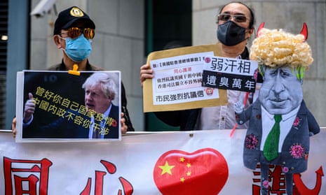 Pro-Beijing activists display a caricature of Boris Johnson outside the British consulate general in Hong Kong