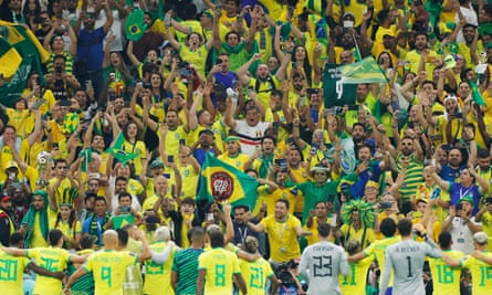 Brazil players celebrate with their fans after the final whistle.