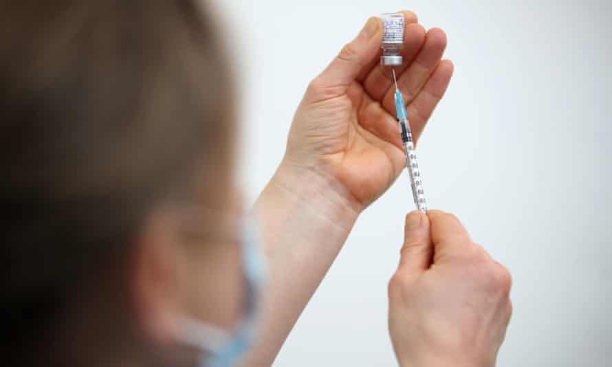 A health worker prepares a Covid vaccine