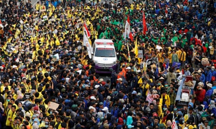 Protesters allow an ambulance to pass through in Jakarta