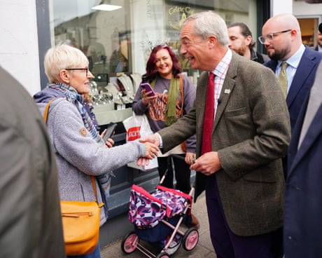 Nigel Farage meets members of the public during campaigning in Caerphilly, south Wales.