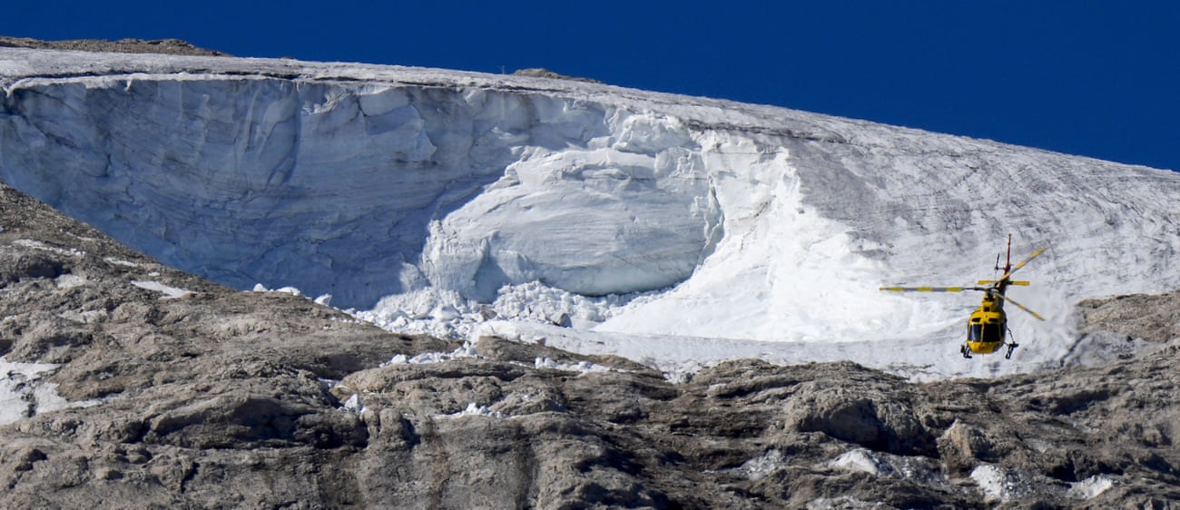 A rescue helicopter flies over the Punta Rocca glacier.