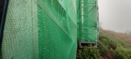 As the wind blows the fog through the mesh, the water droplets are collected.