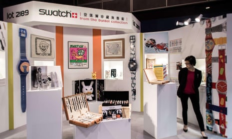 A visitor looks at Swatch watches from the Dunkel collection displayed by auction house Sotheby’s in Hong Kong on April 2, 2015. One of the biggest private collections of Swatch watches in the world will go under the hammer this week.