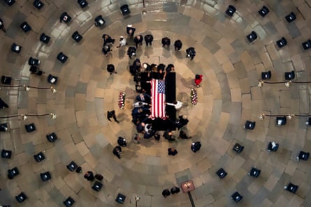 Members of the Congressional Black Caucus touch the flag-draped casket of the late John Lewis
