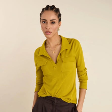 A model wears a deep V collar long sleeve ribbed top in chartreusse