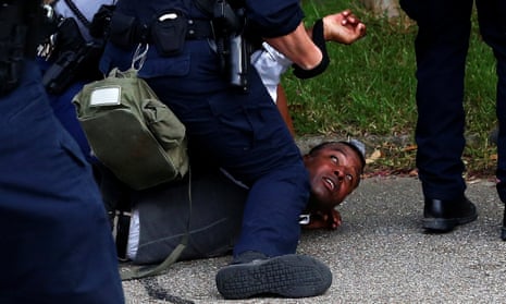 A demonstrator is detained during protests in Baton Rouge, Louisiana, July 10, 2016. 