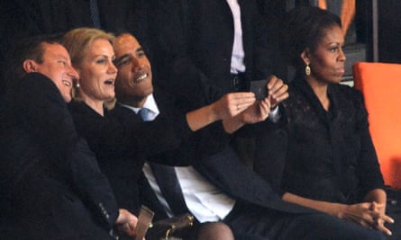 US president Barack Obama, British prime minister David Cameron and Denmark’s Prime Minister Helle Thorning Schmidt pose for a selfie alongside Michelle Obama