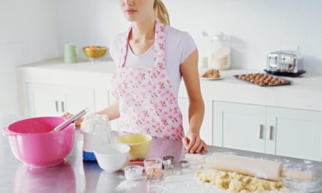 Woman preparing to make biscuits<br>GettyImages-56166334 housewife wearing apron in kitchen