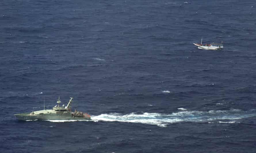 An Australian navy vessel shadows a boat believed to be carrying asylum seekers off Indonesia.