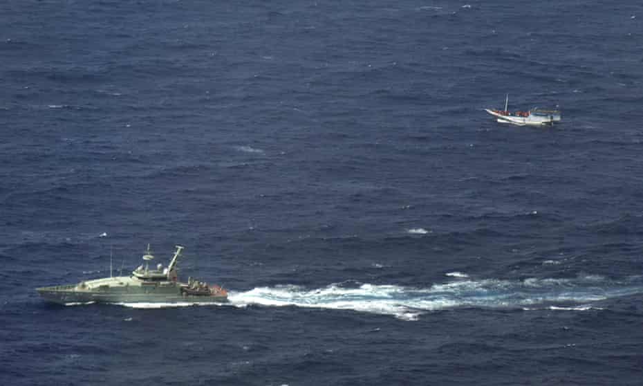 An Australian navy boat shadows a boat believed to be carrying up asylum seekers off Indonesia.
