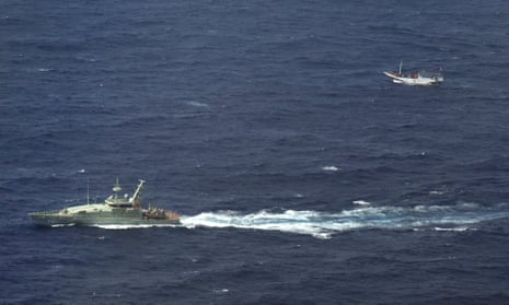 An Australian navy vessel shadows a boat believed to be carrying up to 180 asylum-seekers off Indonesia and sailing towards Australian waters.