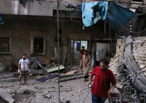 Medics inspect the damage outside a field hospital after an airstrike in the rebel-held al-Maadi neighbourhood