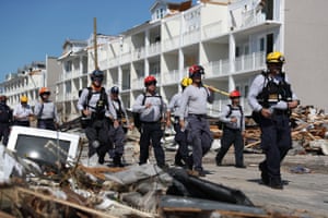 Members of the South Florida Search and Rescue team search for survivors