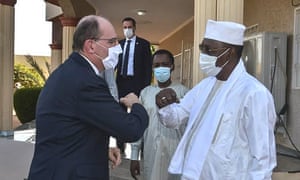 French prime minister Jean Castex (L) is elbow greeted by Chadian president Idriss Deby at the latter’s winter residence in Amdjarass, capital of the province of Ennedi-East on 31 December, 2020, where he has also spent New Year’s Eve with French soldiers deployed in Sahel.