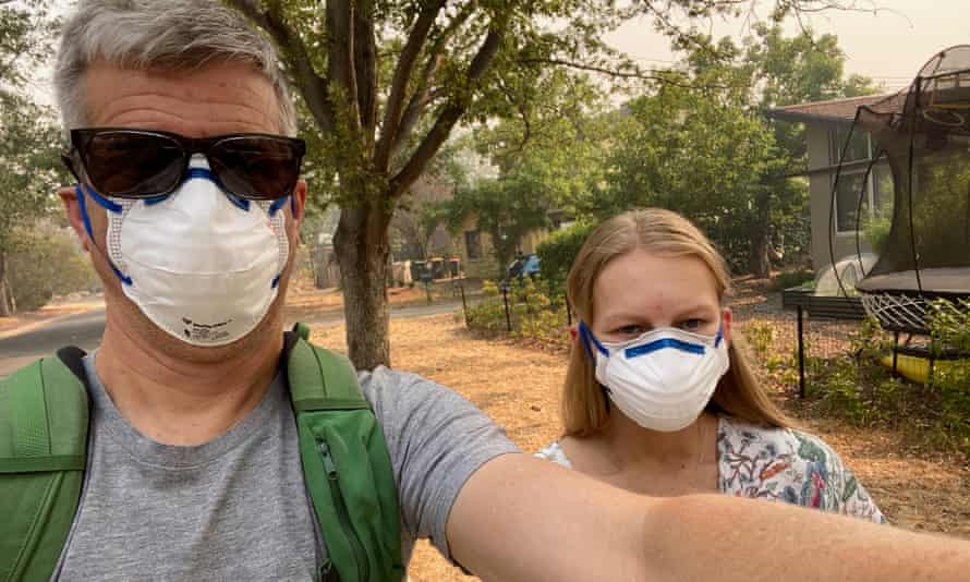 Shaun Humphreys and Lilia Boag Humphreys walk to the shops in smoke-filled Canberra in December 2019
