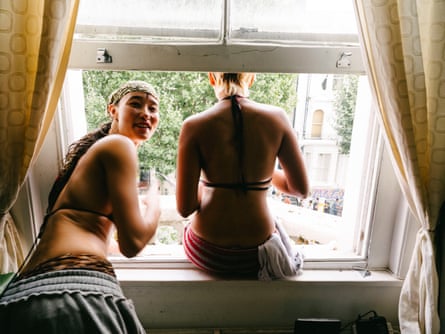 Maya and Violet looking out of a sash window