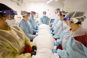 Reback helps with proning a Covid-19 patient. Proning is the process of turning a patient with precise, safe motions from their back to their stomach to help get more oxygen into the blood.