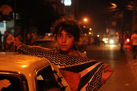 A girl holding a Palestinian flag