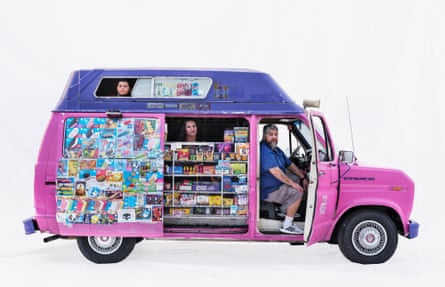Ice-cream sellers Victoria and Mario and their grandson Giovanni in a Ford van in Santa Monica, California, US. Their can is pink with a purple roof through which their grandson looks