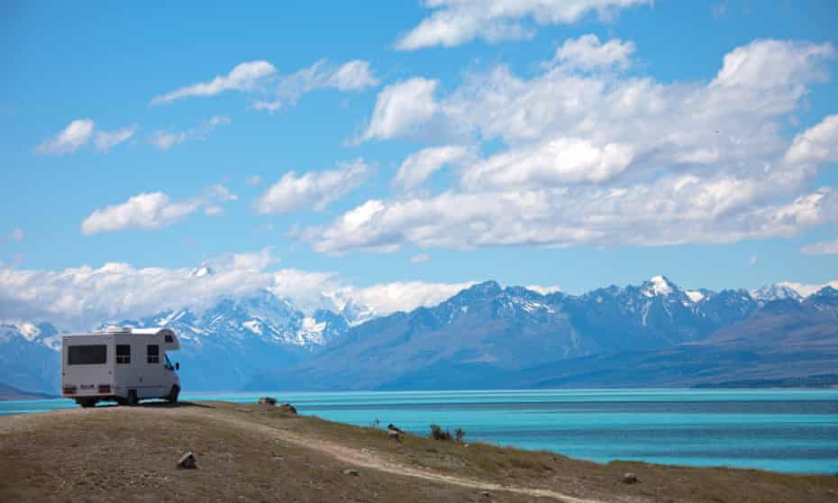 tourist van overlooking lake and mountains