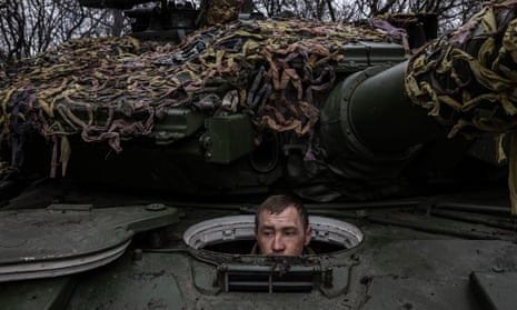 Soldiers of the 214th Battalion prepare a tank for battle
