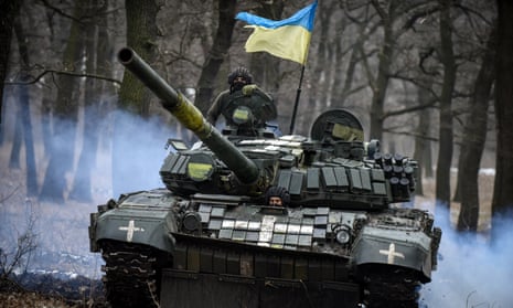 A Ukrainian T-72 tank manoeuvres through the trees in the Donetsk region, eastern Ukraine, on Wednesday