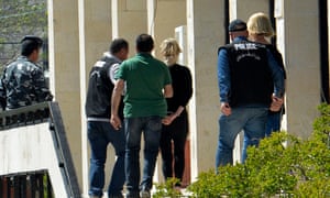 Lebanese police escort Sally Faulkner (centre, in black) and 60 Minutes reporter Tara Brown (right) from court in Beirut