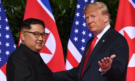two men in front of flags