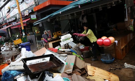 A shop owner at a traditional market damaged after torrential rain in Seoul.