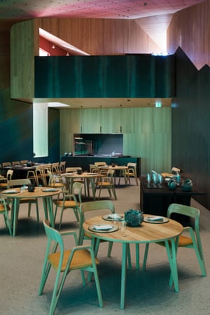 Interior of Under restaurant with walls in light and dark green, and pink