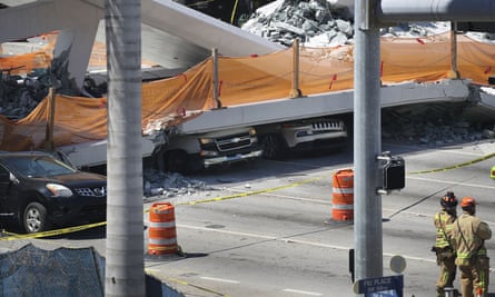 Vehicles are seen trapped under the collapsed pedestrian bridge.