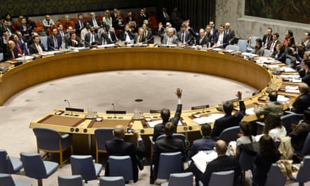 UN security council members show hands for a vote on a resolution condemning Syria’s use of chemical weapons.