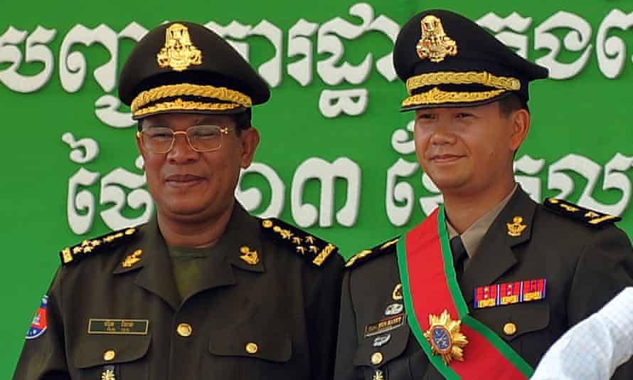 Cambodia’s Prime Minister Hun Sen poses with his son Hun Manet during a ceremony at a military base in Phnom Pen