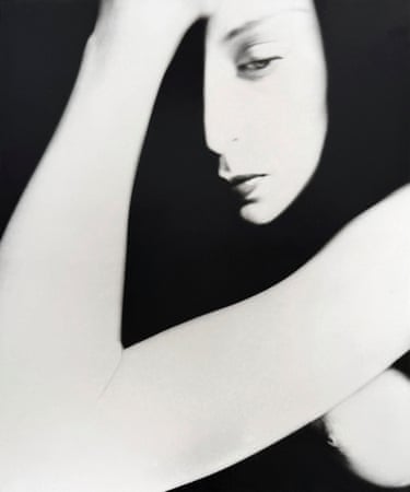 black and white image of a woman holding her head and looking down