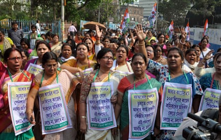 Activists protest in Kolkata against the Indian government’s decision to link free lunch meals for children with the national the Aadhaar ID card.