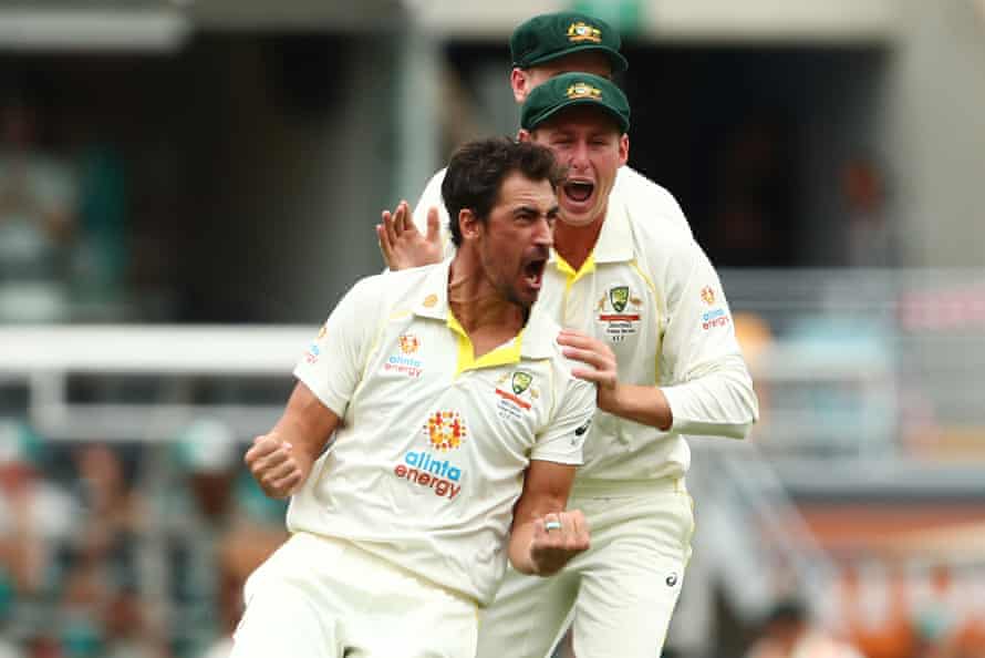 Mitchell Starc celebrates dismissing Rory Burns with the first ball.