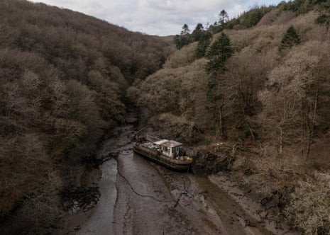 A large abandorned boat lies on the Ponsontuel Creek near Gweek.